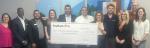 Representatives from KeyBank and Enterprise Community Partners shown with a grant check for $300,000.